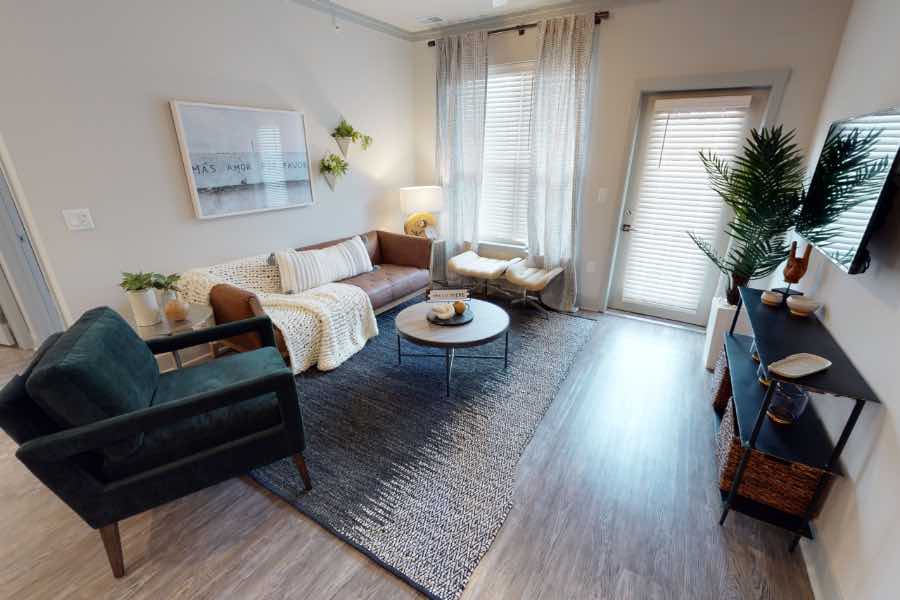 Sofa, chairs, tables, and wall decor in apartment living room